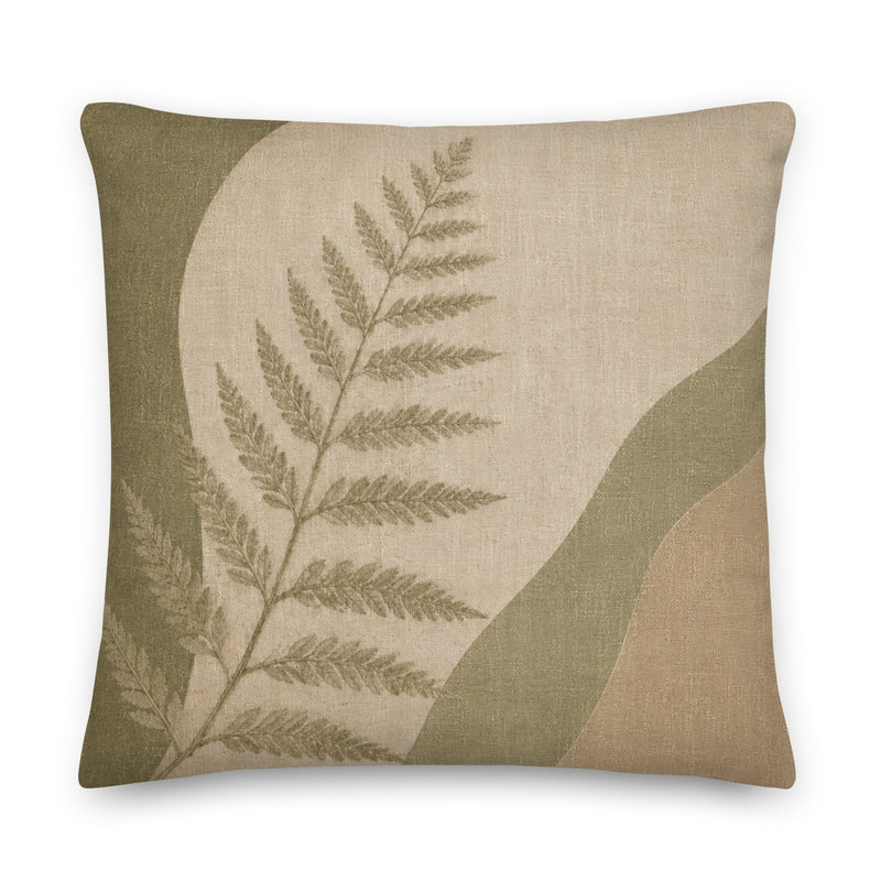 Decorative pillow with fern design on a beige background