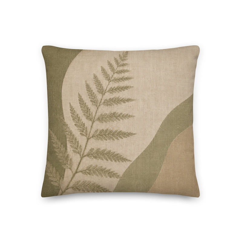 Decorative pillow with fern leaf design on a beige background