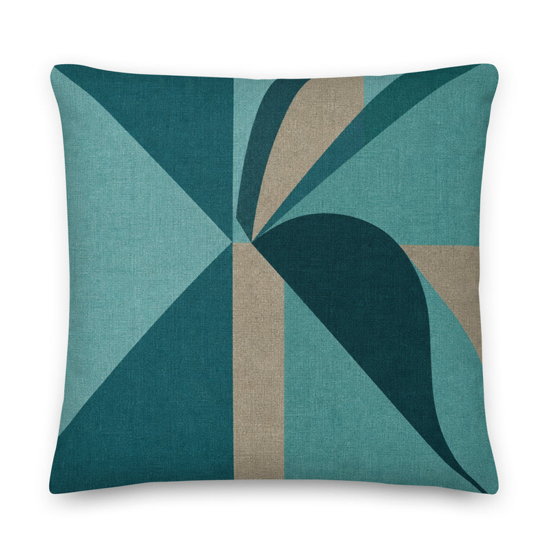 Decorative pillow with geometric pattern in teal and brown on a white background