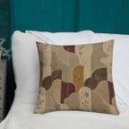 Decorative pillow with abstract pattern on a white surface against a teal wall