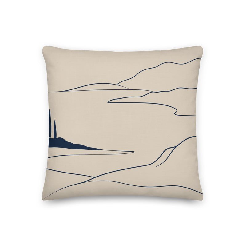 Beige pillow with abstract black line art on a white background