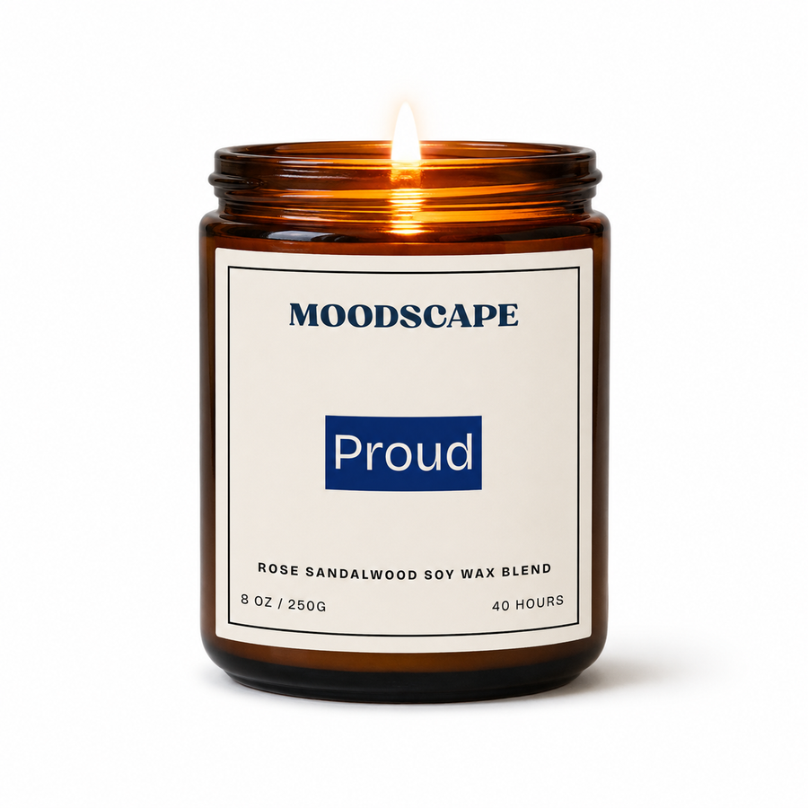 Moodscape candle labeled 'Proud' with a lit flame on a white background