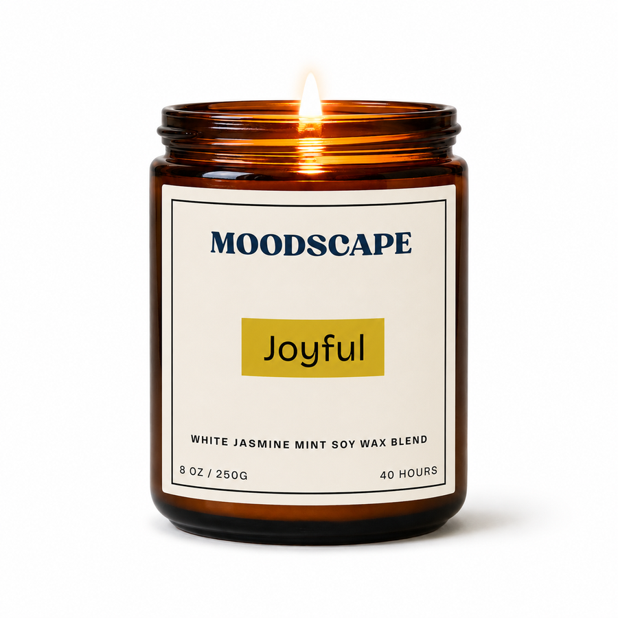Moodscape 'Joyful' candle in an amber jar on a white background