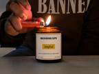 Moodscape Joyful candle in a amber jar lit by the owner wearing BANNED hoodie