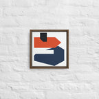 Framed abstract art piece with geometric shapes on a textured white wall