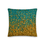 Decorative pillow with gold and teal pattern on a white background