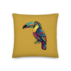 Colorful toucan design on a mustard yellow pillow