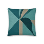 Geometric patterned pillow with teal and brown colors on a white background