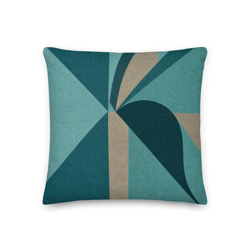Geometric patterned pillow with teal and brown colors on a white background