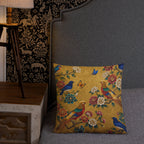 Decorative pillow with floral and bird pattern on a gray couch