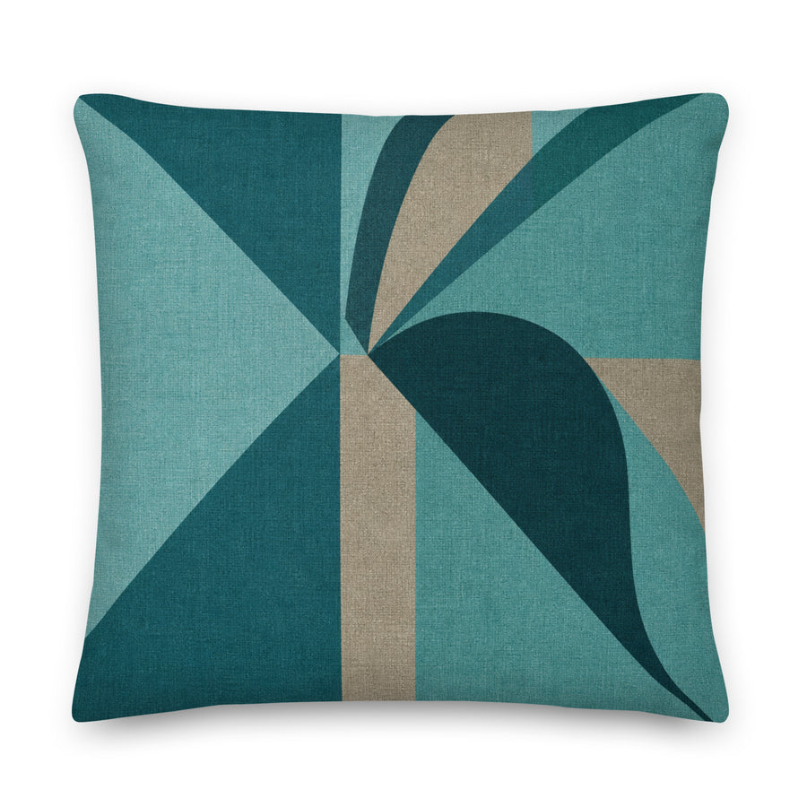 Decorative pillow with geometric pattern in teal and brown on a white background