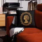 Decorative pillow with a portrait design on a red couch in a living room setting.
