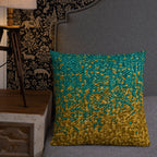 Decorative pillow with gold and teal pattern on a gray couch