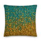 Decorative pillow with gold and teal pattern on a white background