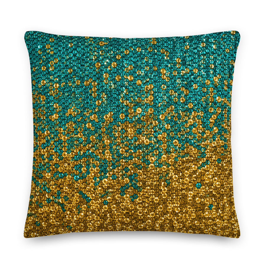Decorative pillow with gold and teal pattern on a white background