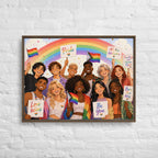 Framed artwork of a diverse group of people holding Pride-themed signs on a white brick wall.