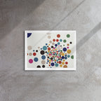 Framed artwork with colorful dot pattern on a gray wall