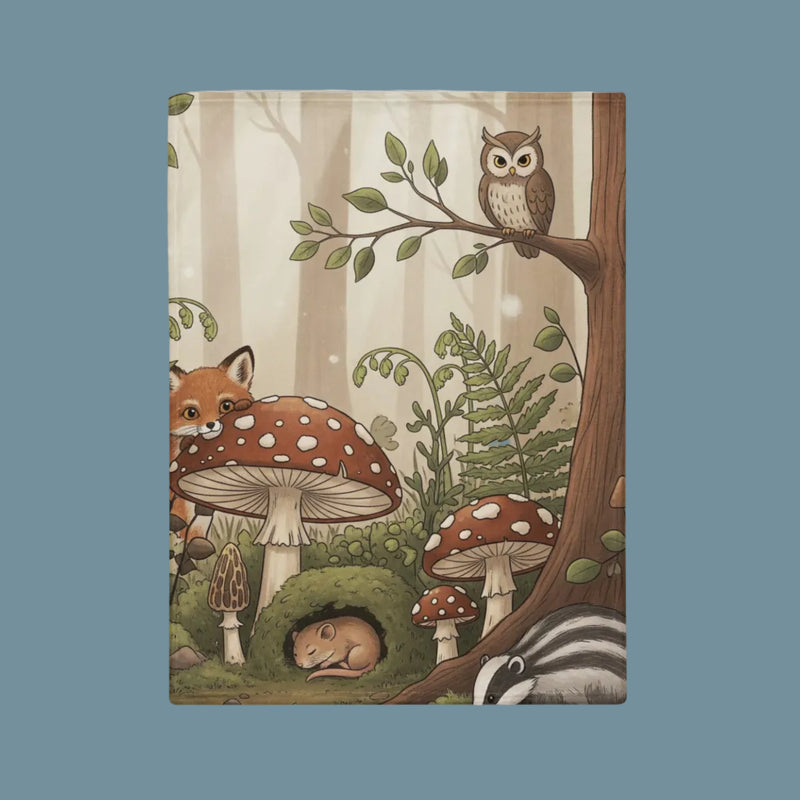 Baby blanket with cottage core vibe in woodland setting including baby fox, owl, mushrooms and trees