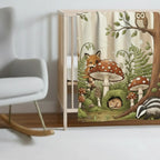 Baby blanket in a nursery with cottage core vibe. Blanket scene includes baby fox, owl, mushrooms and calm forest