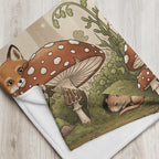 Folded Woodland Mushroom Forest Baby Blanket featuring baby fox and sleepy animals